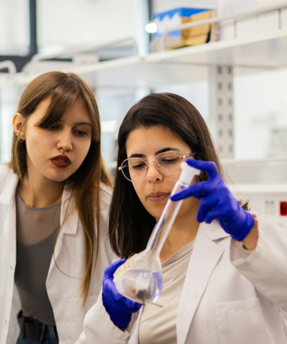 Researchers working with laboratory equipment in a peptide research laboratory